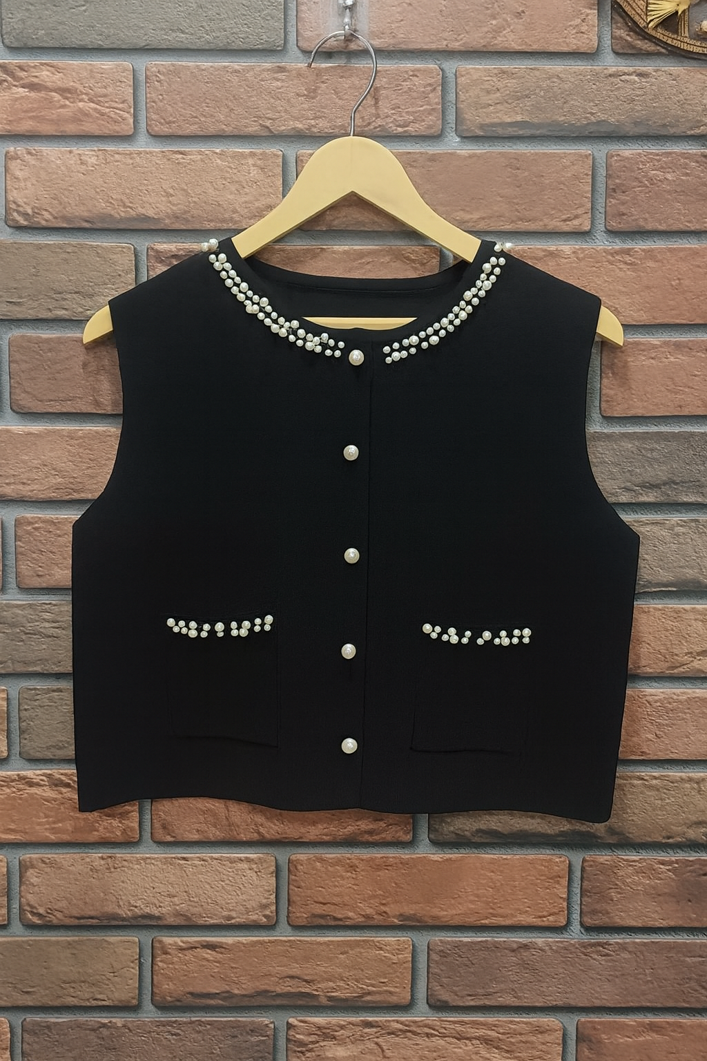 black ribbed knit dress paired with a pearl-detailed shrug