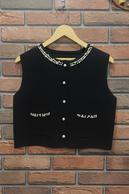 black ribbed knit dress paired with a pearl-detailed shrug